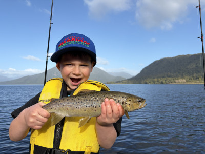 Lockie Kersten with a well conditioned brown trout caught at Lake Brunner.