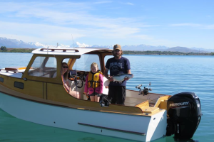 WFR2526.131 Angler Casey Dixon with a well conditioned rainbow trout with his daughter Bella and wife Ashley, enjoying all Lake Benmore has to offer.
