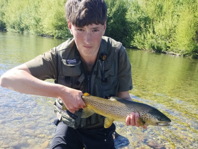 WFR2627.11 Finn Stevens with the first trout he’s caught using his own self tied fly.
