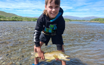 WFR2526.64 Sefton Stevens, age 8, about to release a Tekapo River brown that succumbed to a well presented soft bait.