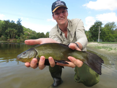 WFR1820.52Fish Game Officer Hamish Stevens displays a Centennial Park tench Credit R Adams