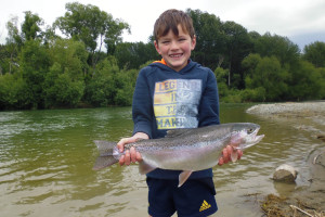 WFR1819.24 Finn Stevens display his rare catch a rainbow trout from the Opihi River photo credit H Stevens