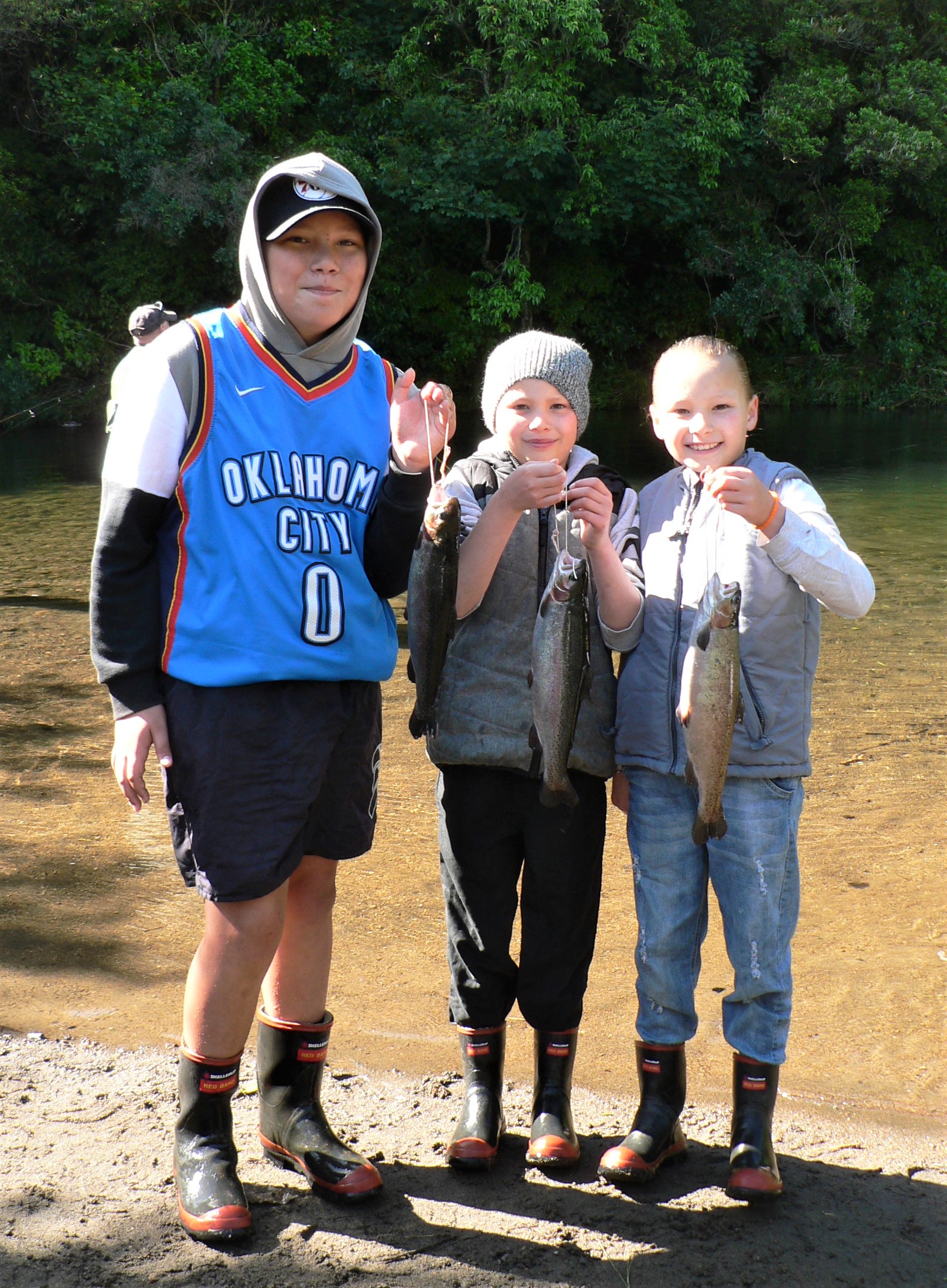 TRL2Dec2020. Jaxon Charlotte Paije Teohaere with their catches at the Stratford kids trout fishing day.