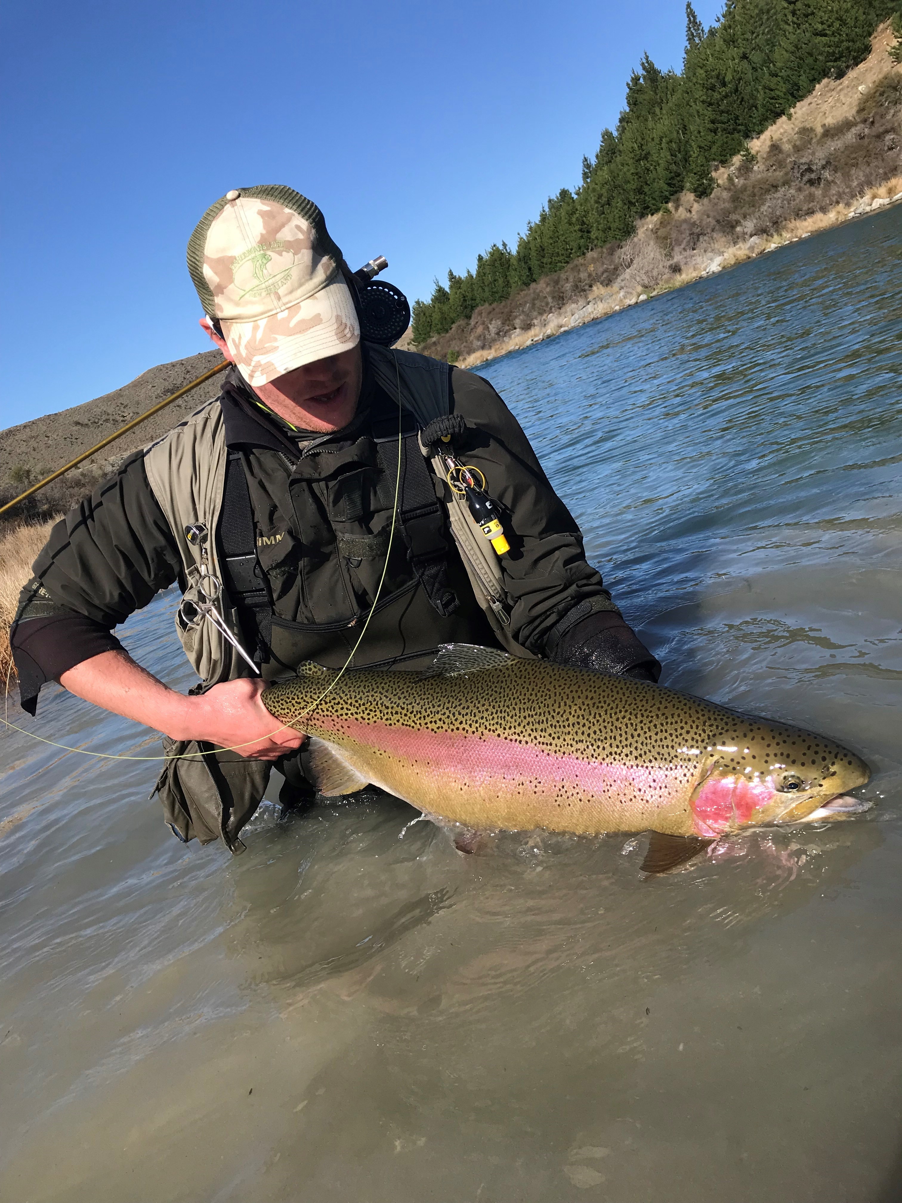 Ben Sowry holds a beautiful big Ōhau River rainbow trout RLcsi1 Ben Sowry with holds a beautiful big Ohau River rainbow trout
